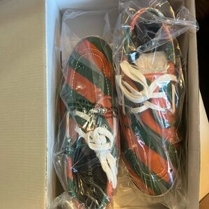 Green and orange striped shoes university of Miami colors